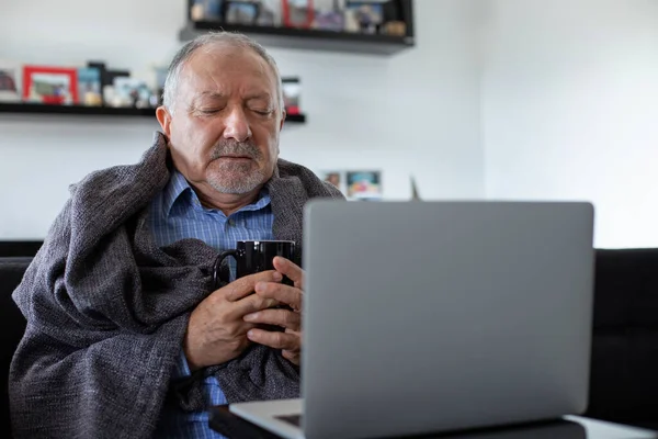 A senior businessman working at home office when he is flu and cold , working at home office concept with sickness