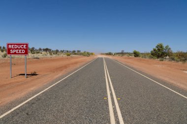 Avustralya kırsalında bir otoyolda kırmızı bir işaret var. 