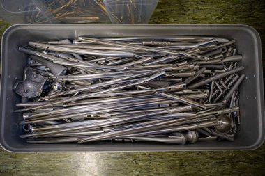 in a large steel box are many different surgical implants made o