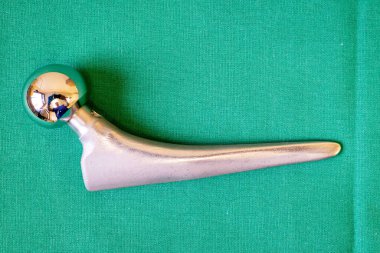 various surgical implants made of steel and titanium lie on a gr