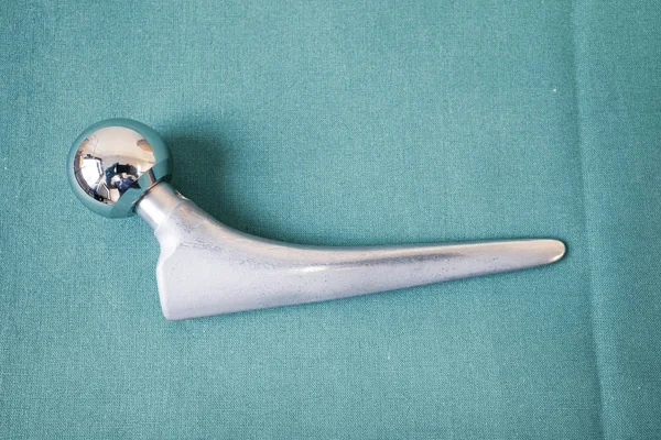 various surgical implants made of steel and titanium lie on a gr