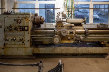 An ancient Romanian lathe stands in a small workshop