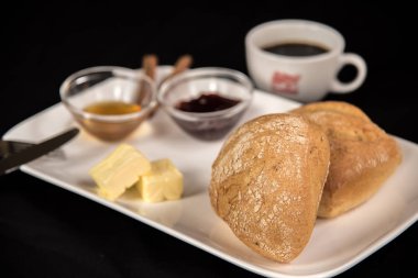 on a dark background stands a plate with a sweet breakfast and a