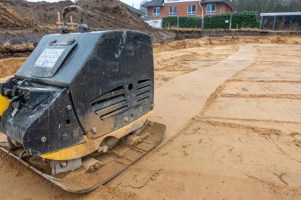 A building site there is a vibrator preparing the ground for fou — Stock Photo, Image