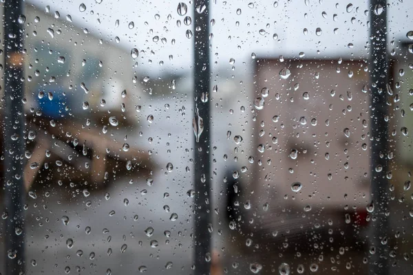 There are large raindrops on a barred window pane — Stock Photo, Image