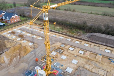 Bir fabrika binasının sütunlarının beton temelinin atıldığı büyük bir inşaat alanının insansız hava aracı görüntüleri