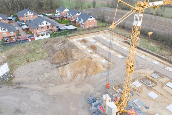 Drone images of a large construction site on which the concrete foundation for the columns of a factory building is being cast