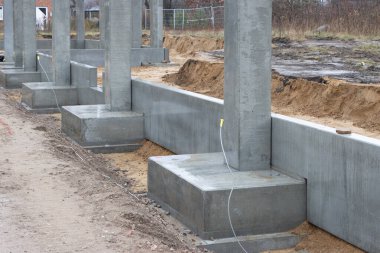 Büyük bir inşaat sahasına bir fabrika binası için beton sütunlar dikildi