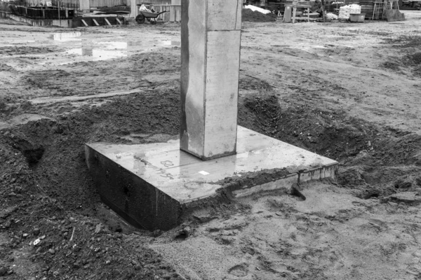 Concrete columns for a factory building are erected on a large construction site