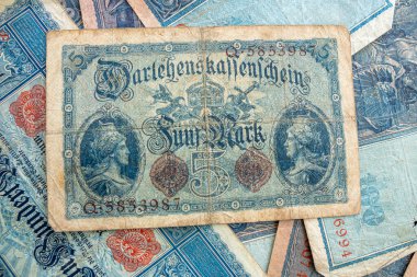 old historical German banknotes lie spread out on a table clipart