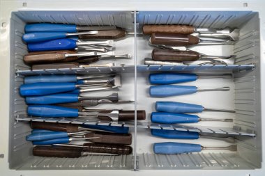 Farklı cerrahi keskiler bir çekmecede yan yana yatar.