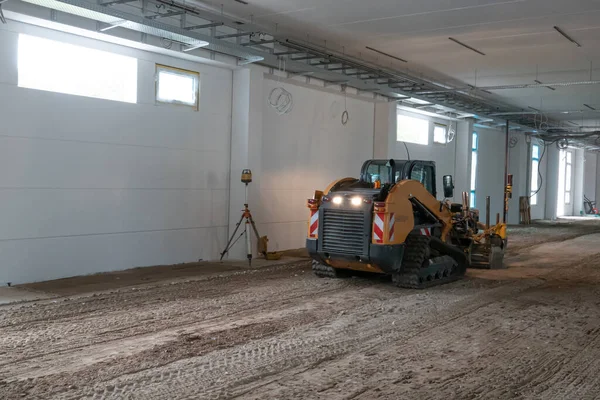 a bulldozer levels the ground on a construction site