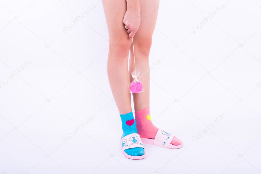 Female smooth legs in colored socks. Epilation.