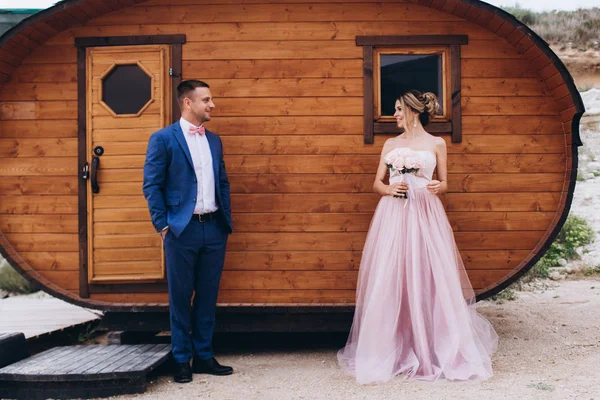 Deniz kıyısında, ahşap evin yanında birbirini seven bir çift. Düğün için. Yeni evliler.