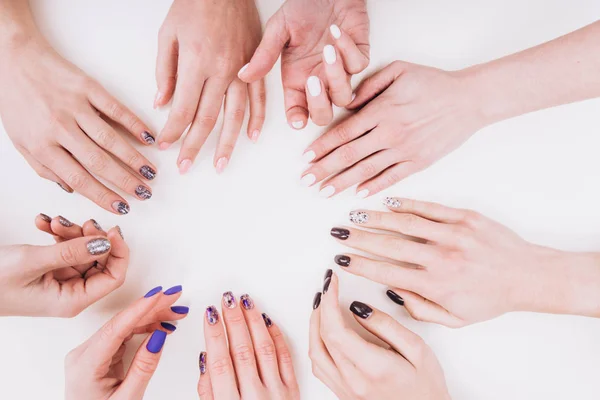 Delicate girlish hands with a stylish manicure in the form of a circle.