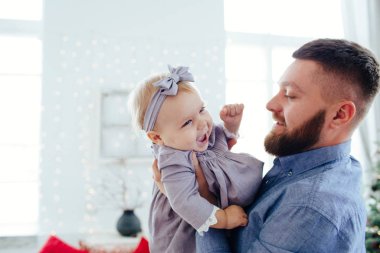 Dad hugs daughter. The best dad in the world. Father is playing with a child.