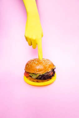 Juicy burger on a pink background. Place for text.