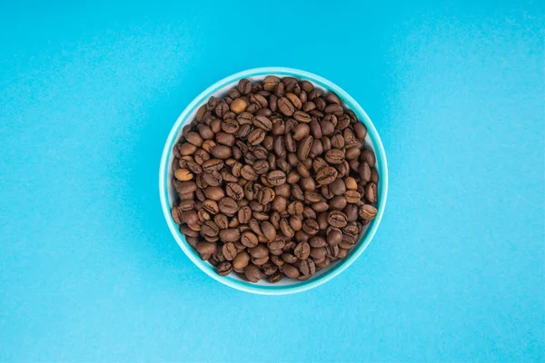 Cup with grains of coffee. Abstraction and coffee minimalism.