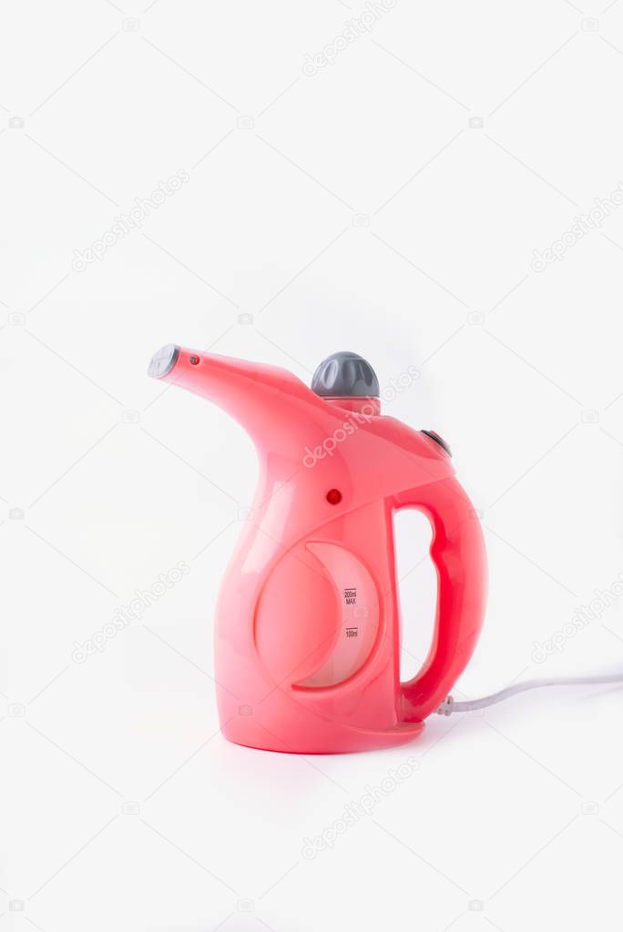 Garment steamer, pink portable iron for home isolated on white background