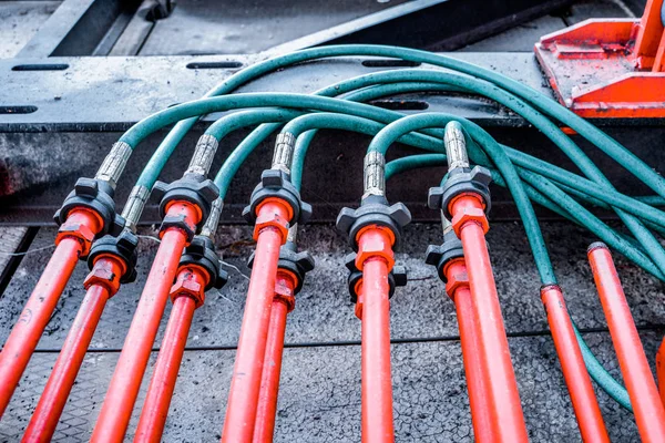 Hydraulic pressure pipes system of construction machinery. Close up shot of hydraulic pressure hoses. Block hydraulic hoses. High pressure hoses are connected by hydraulic connectors