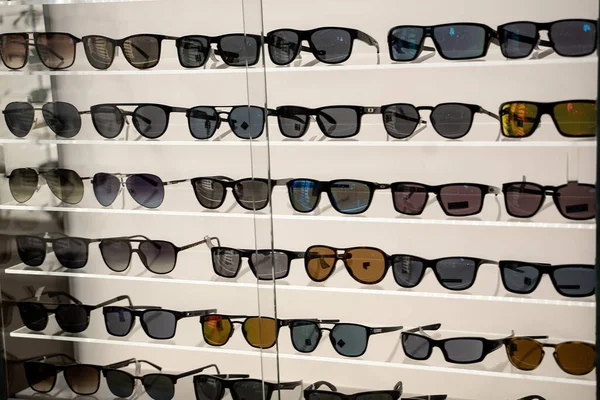 Many sunglasses on display in shop. Fashion Sunglasses in shop.
