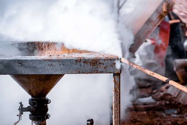 Worker use high pressure steam jet to cleaning splashing the dirt of tube bundle in industrial areas, chemical products or oil and gas plants.