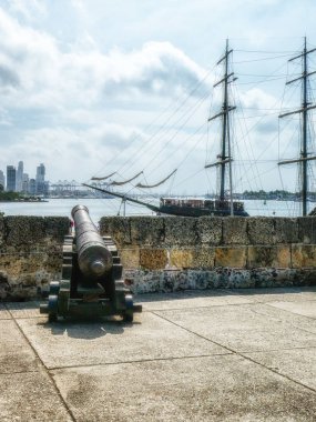 Cannons In The Old City Of Cartagena With The New City In The Ba clipart