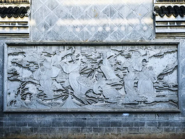 A detailed stone carving decorating a wall at the entrance of the town, Zhujiajiao, China.