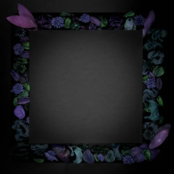 Leave frame with dry green, purple flowers on black background, top view, copyspace
