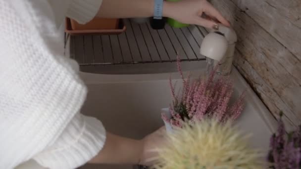 Young Woman White Pullover Watering Flowers Tap Kitchen Home — Stock Video