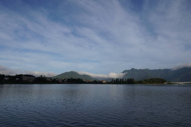 Bulutlu bir günde dağ gölünün manzaralı görüntüsü