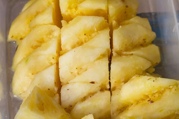 Pineapple fruit cut on chopping board