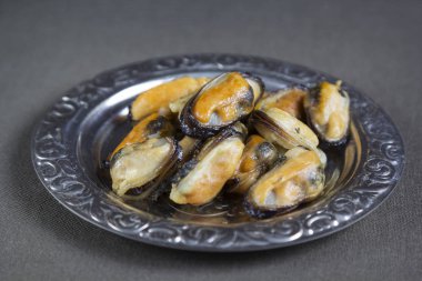 Kızarmış midye metal bir plaka üzerinde