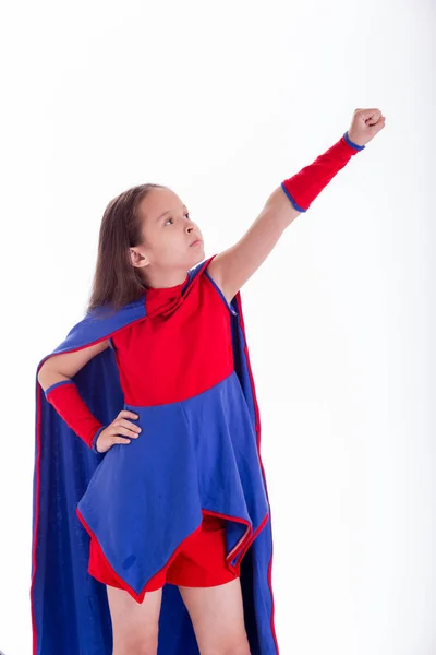 Girl in superhero costume holding arm up — Stock Photo, Image
