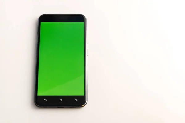 Teléfono inteligente con pantalla verde aislada en blanco — Foto de Stock