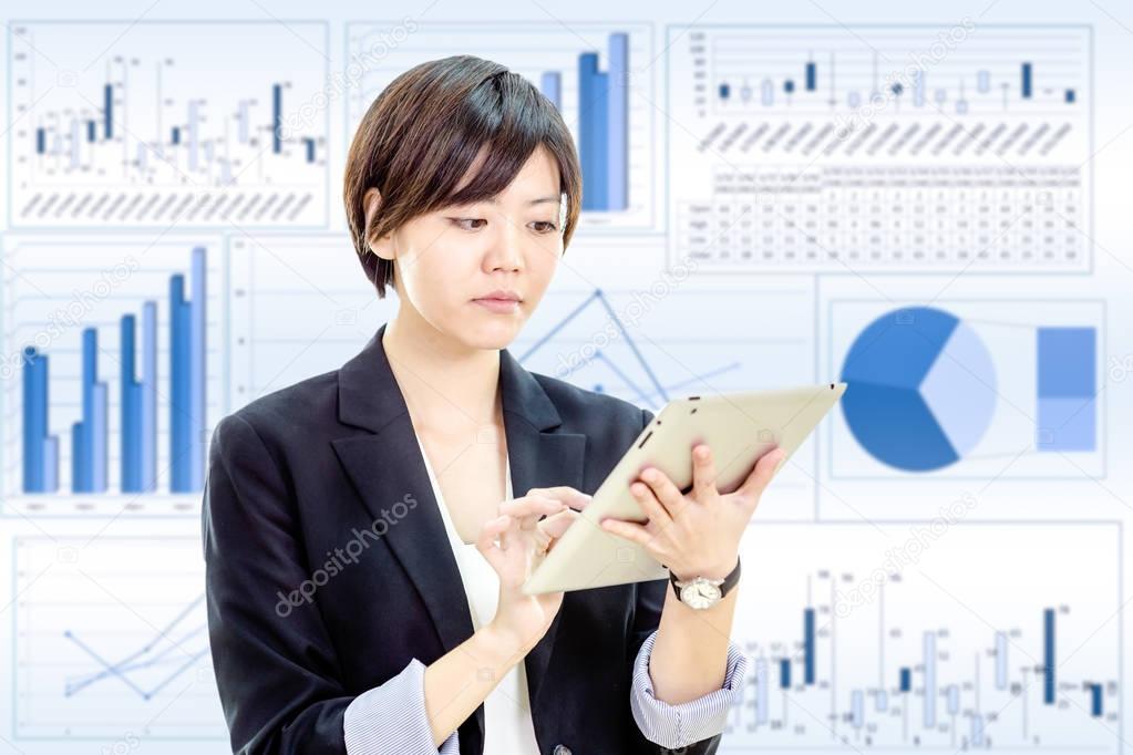 Asian businesswoman working on tablet computer