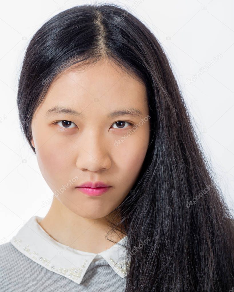 Serious looking Asian teenager