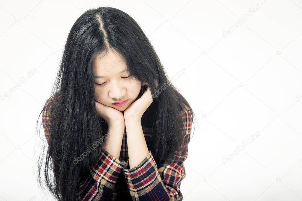 Asian teenager sad with head in hands