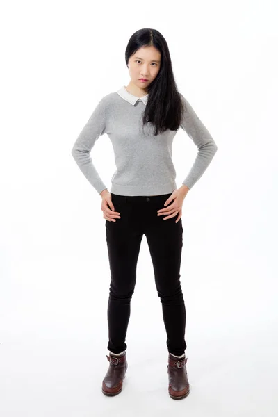 Chinese teenager standing with hands on hips — Stock Photo, Image