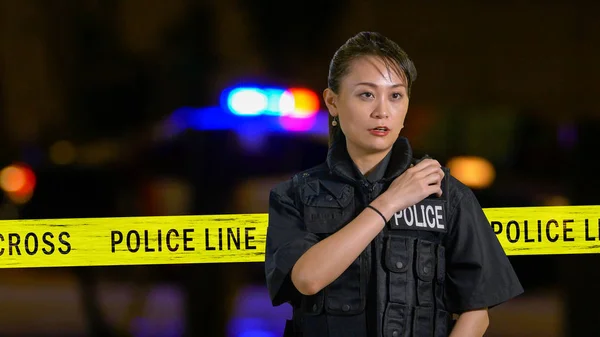 Поліцейський американців азіатського походження, використовуючи поліції радіо — стокове фото