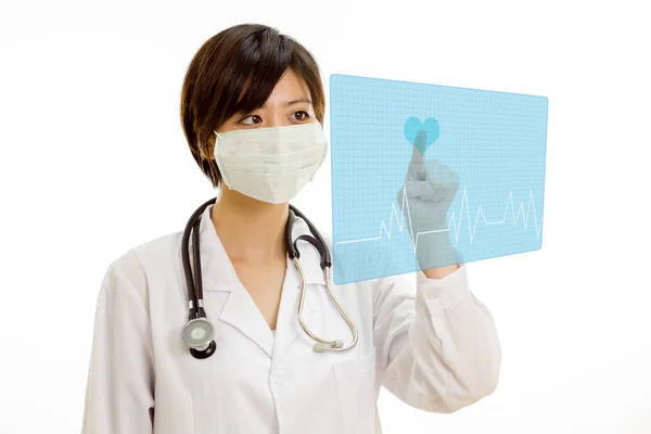 Asian doctor pressing heart button on virtual interface — Stock Photo, Image