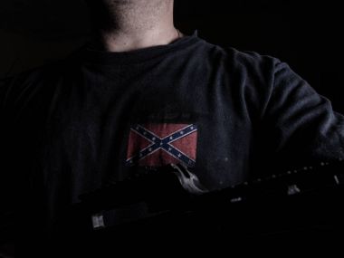 Anonymous man wearing confederate flag t-shirt holding gun clipart