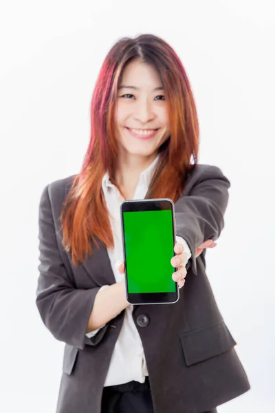 Defocused Asian woman holding out smartphone with green screen — Stock Photo, Image