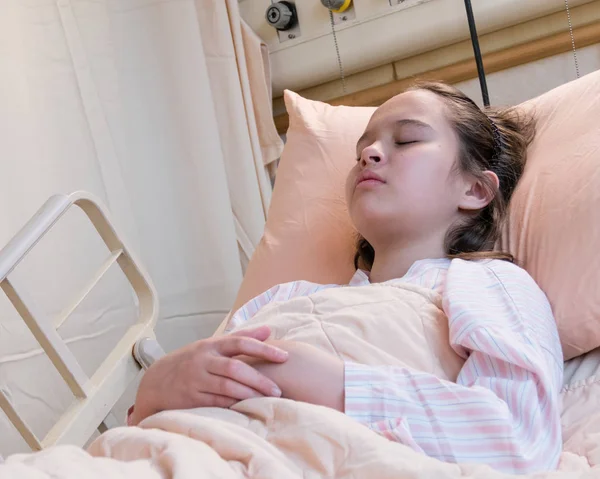 Young tween girl in hospital bed