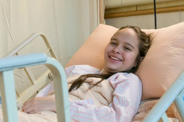 Mixed race tween girl in hospital bed