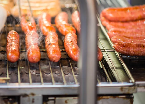 Sausages grilling on barbecue — Stock Photo, Image