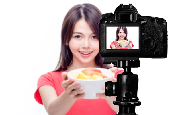 Asian food vlogger with fruit salad behind camera — Stock Photo, Image