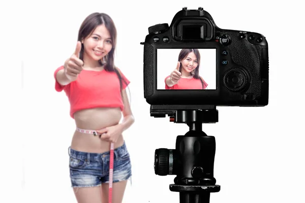 Asian vlogger measuring waist behind camera, social media concep — Stock Photo, Image