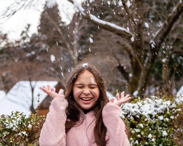 tween girl having fun in snow