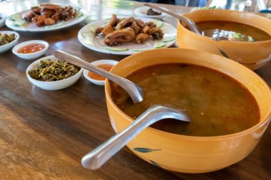 Selection of burmese dishes in rural Myanmar with skinny chicken and traditional soup